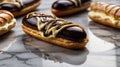 Delicious Chocolate Eclairs Drizzled with Cream on a Marble Surface close up view Royalty Free Stock Photo