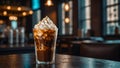 Close-up of chocolate ice with cream on blurry cafe interior background. A glass of iced chocolate coffee on an elegant wooden Royalty Free Stock Photo