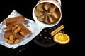 Close-up of chocolate ice cream, milk chocolate and almonds, coffee beans, stick of cinnamon and a slice of dried orange isolated Royalty Free Stock Photo