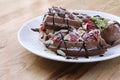 Close up of chocolate ice cream with waffle and fresh strawberry on wood table background Royalty Free Stock Photo