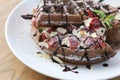 Close up of chocolate ice cream with waffle and fresh strawberry on wood table background Royalty Free Stock Photo