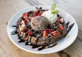 Close up of chocolate ice cream with waffle and fresh strawberry on wood table background Royalty Free Stock Photo