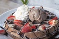 Close up of chocolate ice cream with waffle and fresh strawberry on wood table background Royalty Free Stock Photo