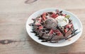 Close up of chocolate ice cream with waffle and fresh strawberry on wood table background Royalty Free Stock Photo