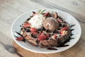 Close up of chocolate ice cream with waffle and fresh strawberry on wood table background Royalty Free Stock Photo