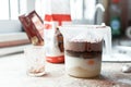 A close-up of chocolate milk liquid being poured into the form of a confectionery syringe in the form mold or mould. Preparation Royalty Free Stock Photo