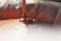 A close-up of chocolate milk liquid being poured into the form of a confectionery syringe in the form mold or mould. Preparation Royalty Free Stock Photo