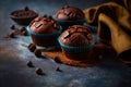 Close up of chocolate muffins. Pieces of milk chocolate on top of cupcakes. Cocoa powder in the background. Royalty Free Stock Photo