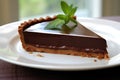 Close up of a chocolate tart on white plate