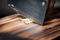 Close-up of chopped or minced fresh ginger Zingiber officinale on a wooden cutting board with a chef knife