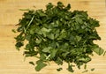 Close up of chopped persley herbs on a wooden chopping board Royalty Free Stock Photo