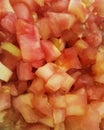 Close-up of chopped tomato in small cubes. Delicious and fresh red salad.