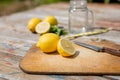 Close-up. Chopping cutting board with sliced lemon, jar, mint leaves, knife and straw on wooden table. Cocktail Royalty Free Stock Photo