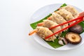 Close up Chopsticks Picking Asian Steam  Dumplings  or Dim Sum a Famous Chinese Food  with Pork and Shrimp on Banana Leaf and Royalty Free Stock Photo