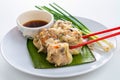 Close up Chopsticks Picking Asian Steam  Dumplings  or Dim Sum a Famous Chinese Food  with Pork and Shrimp on Banana Leaf and Royalty Free Stock Photo