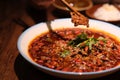 Close up chopsticks picking up traditional Chinese Sichuan cuisine