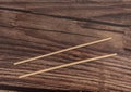 Close-up of chopsticks taking a serving of sushi roll on a table in a restaurant Royalty Free Stock Photo