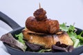 Close up of a chorizo tapa with green leaves on a iron skillet Royalty Free Stock Photo