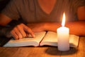 Close up of Christian boys are reading and study bible In the room and lit candles to light, Religious concepts