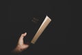 Close up of christian woman hand holding holy bible pray and worship for thank god in church with black background, adult female Royalty Free Stock Photo