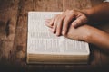 Close up of christian woman hand on holy bible are pray and worship for thank god in church with black background, concept for Royalty Free Stock Photo