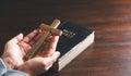 Close up Christian woman hands holding a cross holy and worship. Spirituality and religion Concept, Person holding christian cross Royalty Free Stock Photo