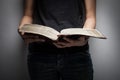 A close-up of a christian woman reading the bible.