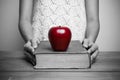 Close-up of a christian woman reading the bible with red apple