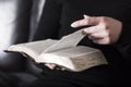 Woman sits in a sofa and read the Bible Royalty Free Stock Photo