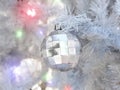 Close up christmas accessories hanging on decorated with lights Christmas tree. Christmas decorations on a spruce branch, copy Royalty Free Stock Photo