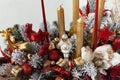 Close-up of a Christmas arrangement of handmade flowers and candles. Christmas mood