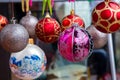 Close up of Christmas Balls Ornaments hanging on the clothespin on the Clothes Drying Rack. Royalty Free Stock Photo