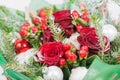 Close-up of Christmas bouquet with flowers and spruce with snow. Royalty Free Stock Photo