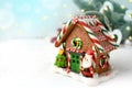 Close up Christmas compositoin with gingerbread house over fir tree on white background. Royalty Free Stock Photo