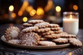 Close up of christmas cookies artfully arranged in a swirl design with a central focus on a gingerbread house cookie, christmas