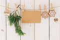 Close up of christmas decoration and blank paper card hanging on wood background Royalty Free Stock Photo