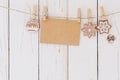 Close up of christmas decoration and blank paper card hanging on wood background