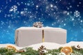 Close-up of a Christmas gift with beautiful blue wintry background Royalty Free Stock Photo