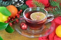 Christmas tea with lemon slice in transparent cup on wooden table Royalty Free Stock Photo