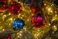 Close-up of a Christmas tree branch with decorative balls, toys and a shining garland. soft focus, background in blur Royalty Free Stock Photo