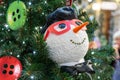 Close up of christmas tree decoration with buttons and snowman. Festive greeting card for winter holidays