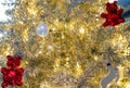 Close up Christmas tree decoration with white balls, silver reindeer and red bear and golden light. Xmas background. Christmas Royalty Free Stock Photo