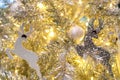 Close up Christmas tree decoration with white balls, silver reindeer and red bear and golden light. Xmas background. Christmas Royalty Free Stock Photo