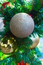 Close up of Christmas tree with golden glittery Christmas balls