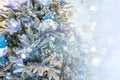 Close up of a christmas tree ornaments baubles with some blue Santa Clauses and snow flake bokeh lights. Christmas card background Royalty Free Stock Photo