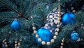 Close-up of a Christmas tree with rose gold and turquoise decorations balls, snowflakes, bows, beads on a blurry background