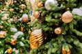 Close up of christmas trees decorated with sparkling balls and garland with lights on. Festive background with copy space for your