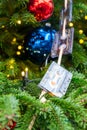 Close up of christmas trees decoration with toys and garlands made of audiocassettes. Festive greeting card for winter holidays