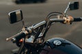 Close-up of chrome handlebars of motorcycle. Stylish custom chopper motobike with chrome details. Soft selective focus Royalty Free Stock Photo