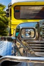 Close-up on the chrome radiator grille, headlight and mud guard of a filipino Jeepney in the Philippines.